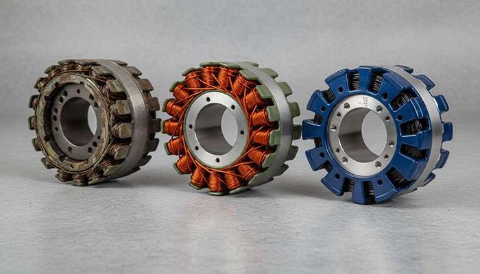 Three automotive stator coils displayed side by side against a gray background for OEM vs aftermarket parts comparison