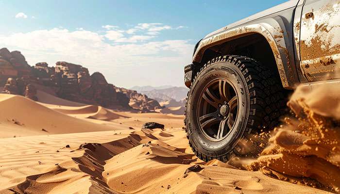 Off-road tires gripping rocks and sand