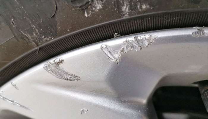 Wheel near a deep pothole that can cause bent or cracked rims.