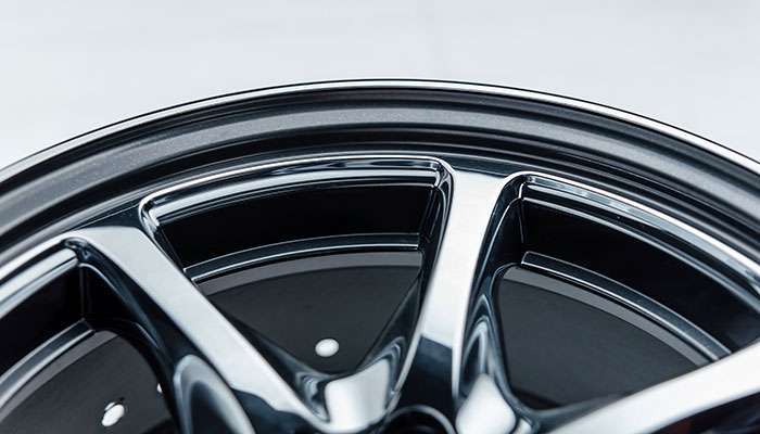 Close-up inspection of a car rim showing detail and surface condition