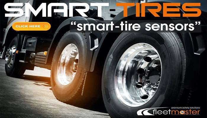 Close-up of truck tires highlighting smart-tire sensors with branding and a Click Here button overlay.