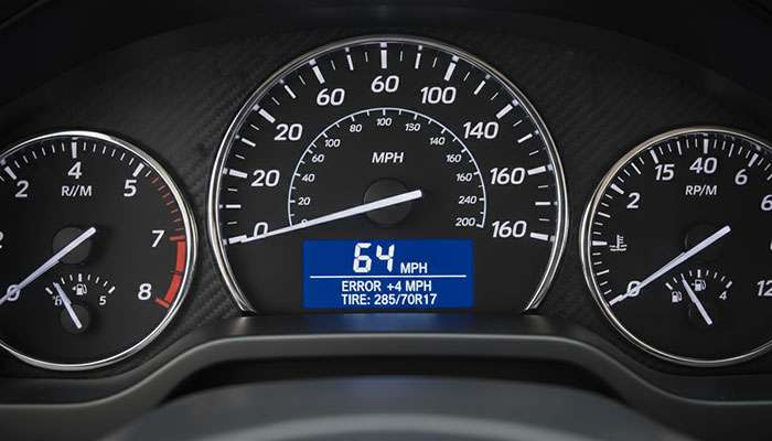 Truck dashboard speedometer displaying inaccurate speed reading due to larger aftermarket tire installation