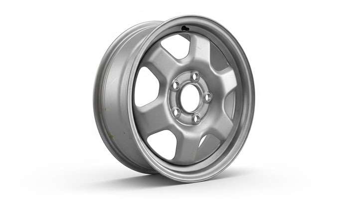 Close-up view of a steel wheel showing its simple spoke pattern and painted silver finish