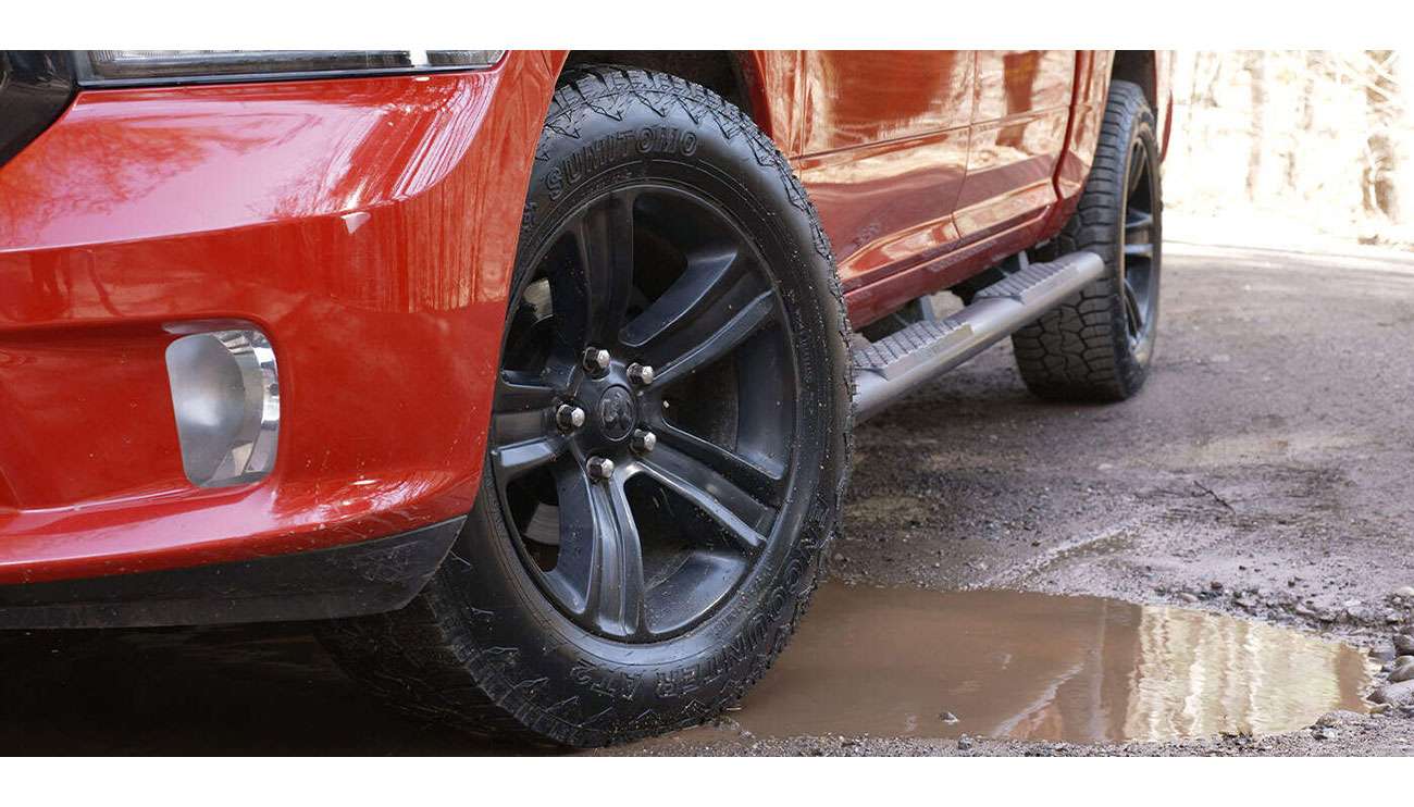 Sumitomo all-terrain tire mounted on vehicle demonstrating durability and performance capabilities
