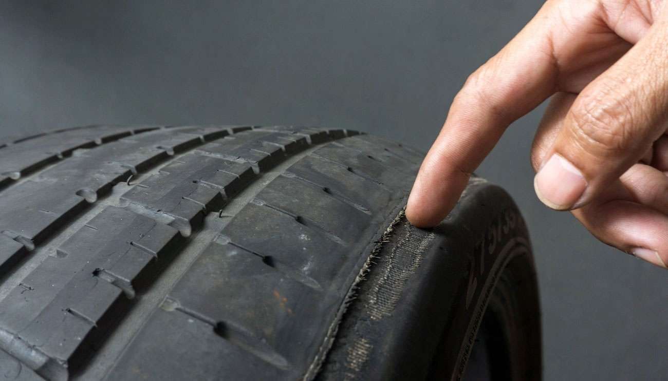 Close-up view of tire tread pattern showing wear indicators and tread depth measurement for tire lifespan assessment