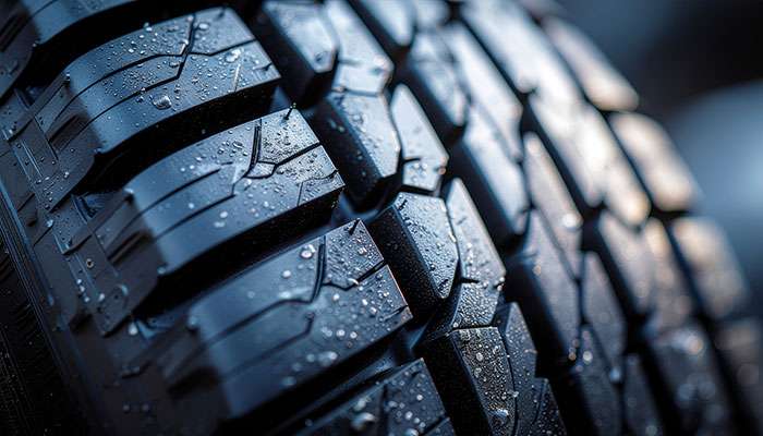 Close-up of a car tire tread showing detailed rubber patterns