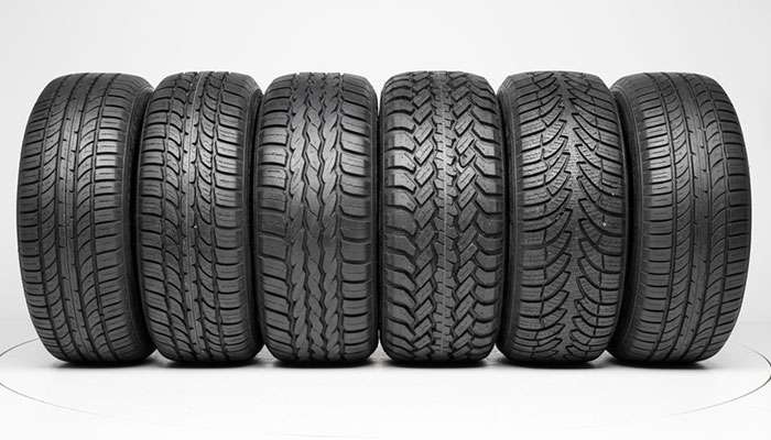 Comparison of seven tire types for passenger cars and light trucks showing tread patterns and noise levels