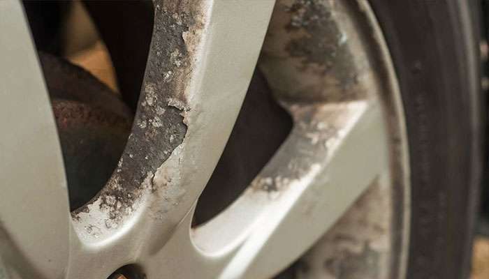 Wheel showing corrosion, rust, and pitting along the rim.