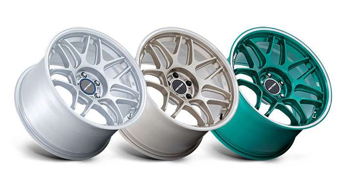 Comparison of cast forged and flow-formed wheels showing distinct designs and manufacturing styles side by side