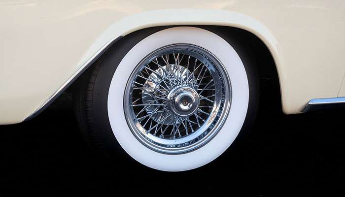 Close-up of a whitewall tire showcasing the distinctive white sidewall on a classic vehicle wheel