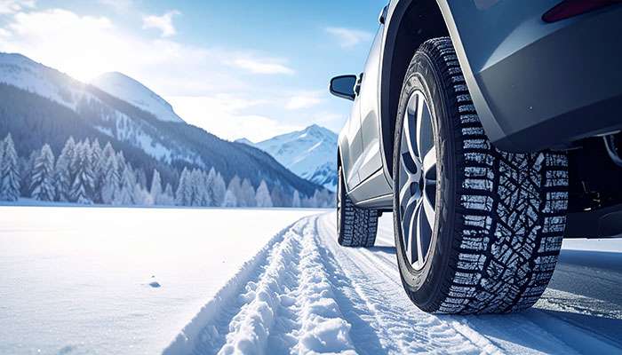 Winter tires with sipes driving on snowy road